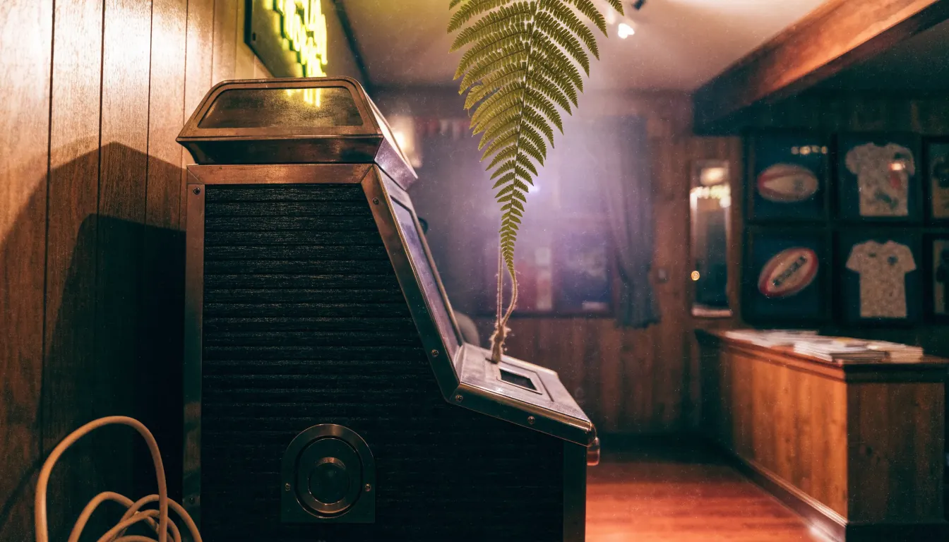 Cozy New Zealand pub interior with unplugged slot machine cabinet
