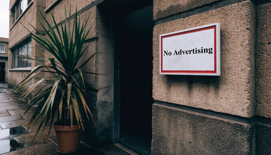 Framed No Advertising notice on wall outside closed New Zealand storefront